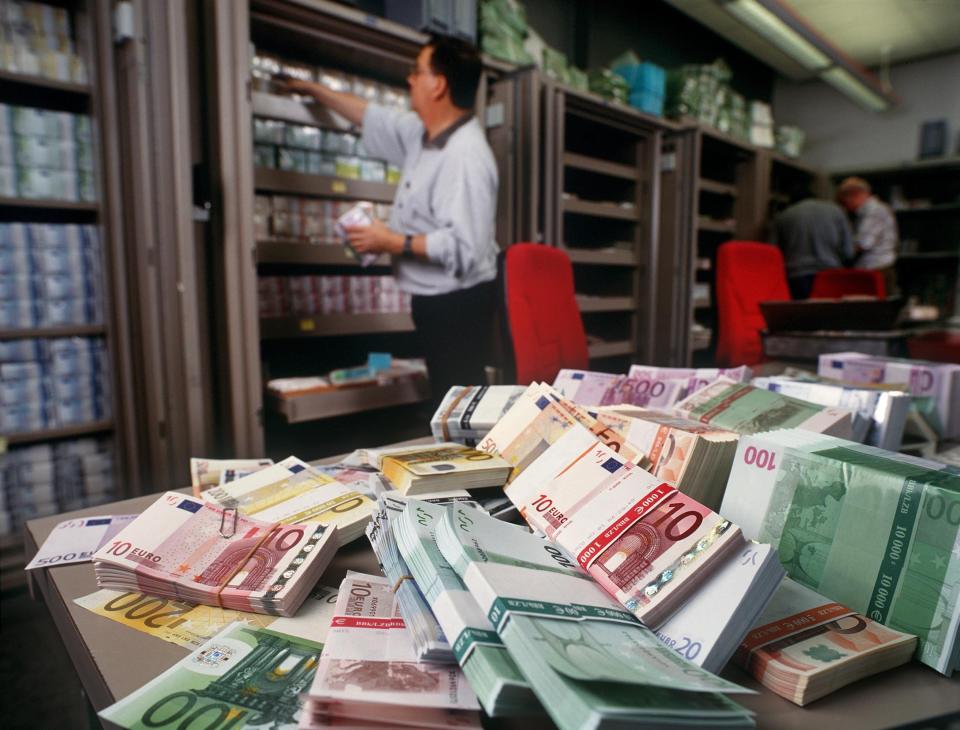 FILE - Euro banknotes are piled up on a table in the foreign exchange department of UBS bank in Zurich, Switzerland, in this Dec. 13, 2001, file photo. The U.S. Treasury Department has branded Vietnam and Switzerland as currency manipulators while putting China and nine other countries on a watch list in an annual report designed to halt countries from manipulating their currencies to gain unfair trade advantages. (AP Photo/Keystone, Martin Ruetschi, File)