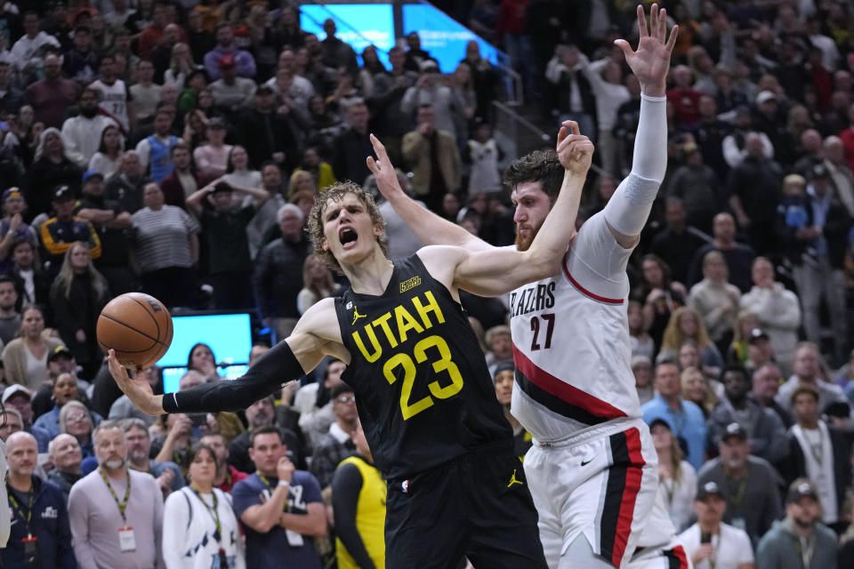 Portland Trail Blazers center Jusuf Nurkic (27) defends against Utah Jazz forward Lauri Markkanen (23) during the second half of an NBA basketball game Saturday, Dec. 3, 2022, in Salt Lake City. (AP Photo/Rick Bowmer)