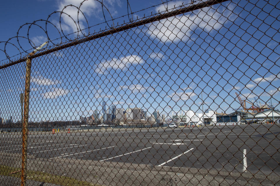 The Manhattan skyline is seen behind the parking lot and terminal of the Brooklyn Cruise Terminal, Thursday, April 2, 2020 in New York. N.Y. New York Gov. Governor Andrew Cuomo announced last week that the terminal with be transformed into a temporary field hospital to increase New York's hospital capacity while cases of the coronavirus skyrocket. (AP Photo/Mary Altaffer)