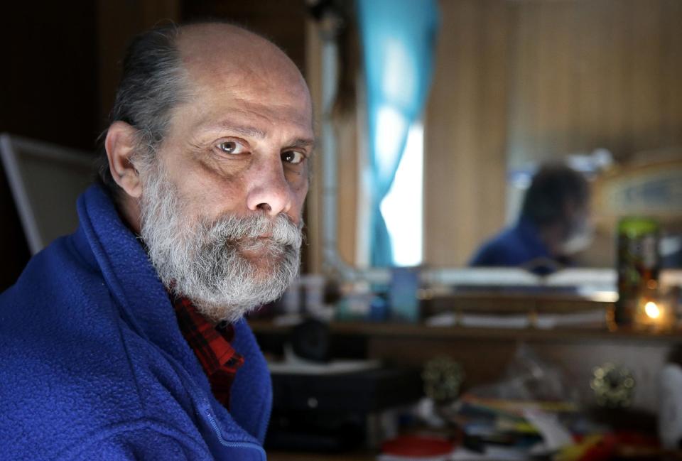 In this Sunday, Dec. 11, 2016 photo U.S. Navy veteran Stephen Matthews, 55, sits for a photograph in the bedroom of a relatives home, in Warwick, R.I. Matthews said he received a voucher that would pay about two-thirds of his rent, but struggled to find an apartment in Rhode Island where he could afford the balance. He got one in West Warwick, R.I. in late December 2016 after a six-month search. (AP Photo/Steven Senne)