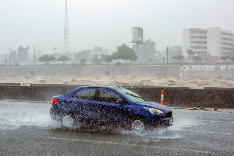 Un auto se desplaza en medio de las lluvias de la tormenta Alberto en la ciudad mexicana de Monterrey, en el estado de Nuevo León, el 20 de junio de 2024 (Julio César AGUILAR)