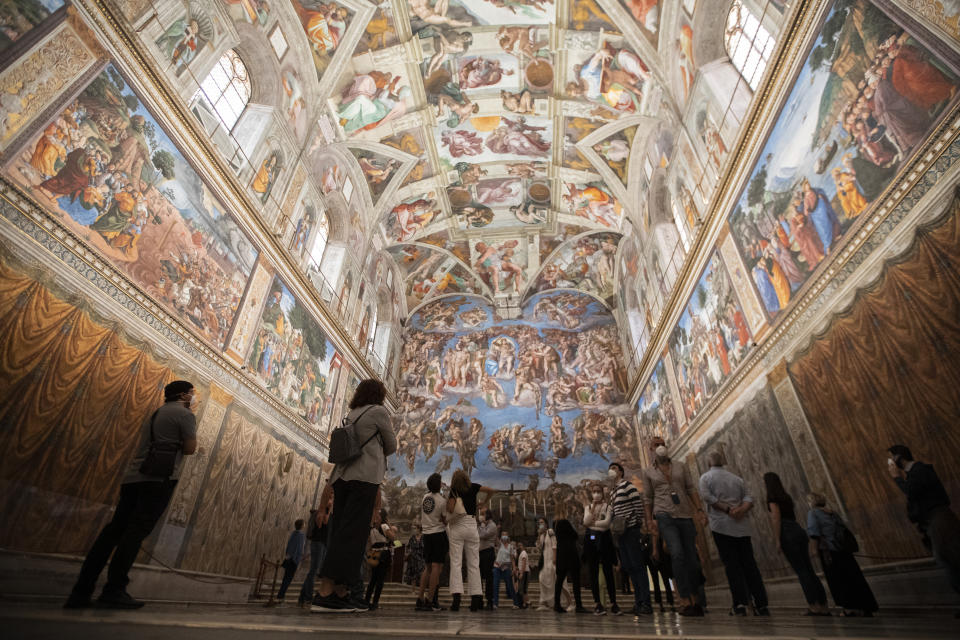 Visitors admire the Sistine Chapel as the Vatican Museum reopened, in Rome, Monday, June 1, 2020. The Vatican Museums reopened Monday to visitors after three months of shutdown following COVID-19 containment measures. (AP Photo/Alessandra Tarantino)