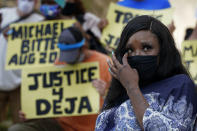 Deja Stallings wipes away tears during a news conference outside city hall Thursday, Oct. 8, 2020, in Kansas City, Mo. Protesters have occupied the lawn and plaza in front of city hall more than a week demanding the resignation of police chief Rick Smith and the officer who knelt on Stallings' back while arresting the pregnant woman last week. (AP Photo/Charlie Riedel)