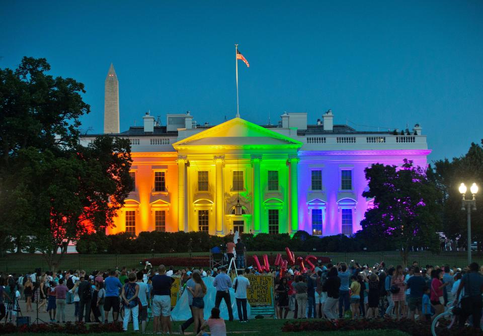 People gather to see the White House illuminated with rainbow colors to mark the Supreme Court's ruling to legalize same-sex marriage on June 26, 2015.