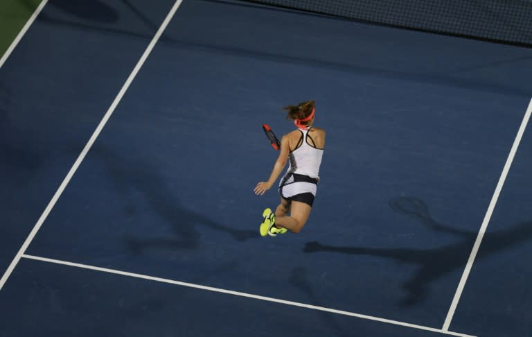 Elina Svitolina of Ukraine returns the ball to Angelique Kerber of Germany during their third semi final women's WTA Tennis Championship in Dubai on February 24, 2017