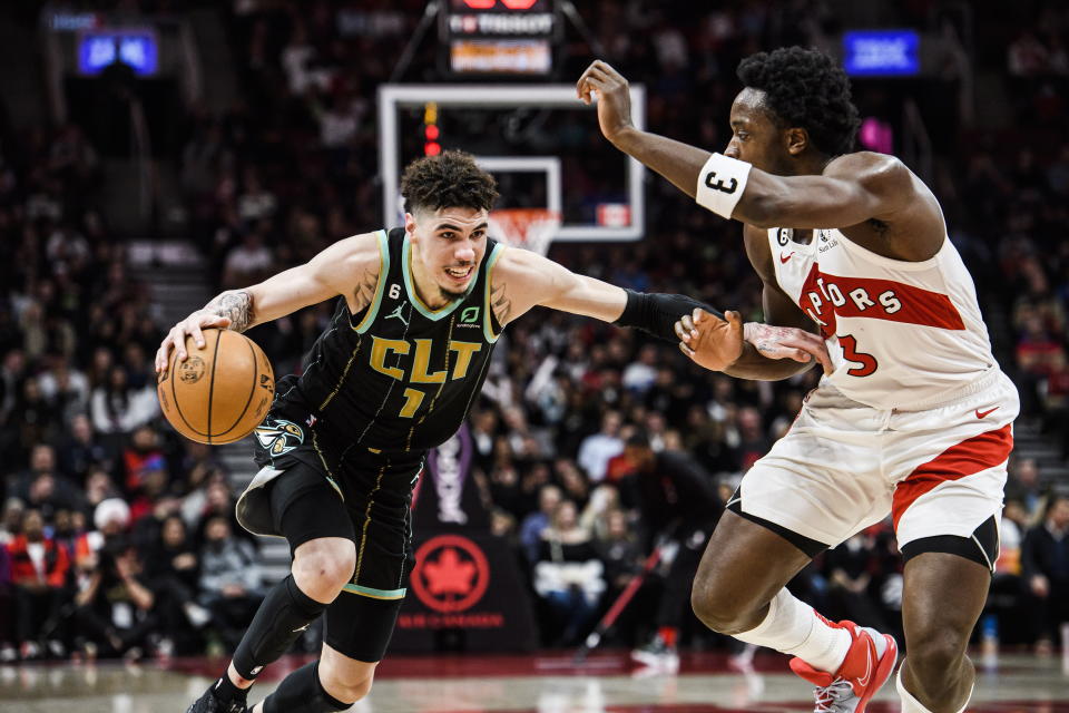 Charlotte Hornets guard LaMelo Ball (1) advances past Toronto Raptors forward O.G. Anunoby (3) during the second half of an NBA basketball game in Toronto on Tuesday, Jan. 10, 2023. (Christopher Katsarov/The Canadian Press via AP)