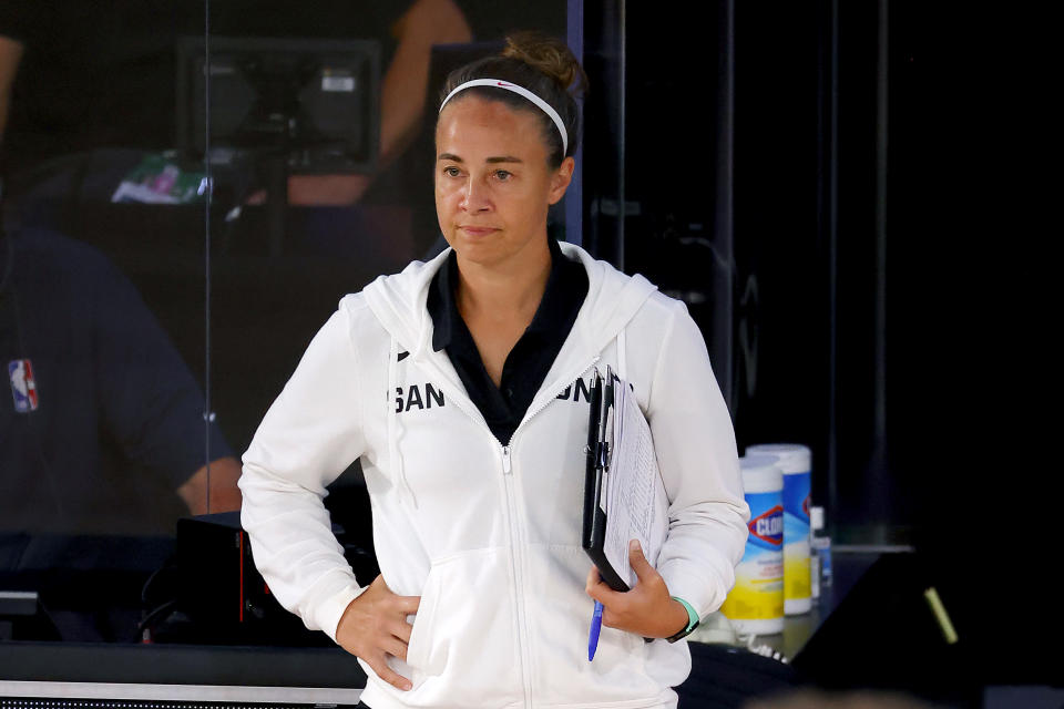 Becky Hammon looks on from the sideline during a Spurs game.