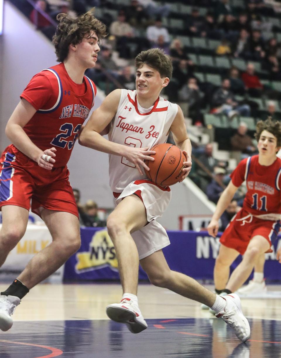 Tommy Lineman of Tappan Zee drives against New Hartford during a Class A NYSPHSAA semifinal basketball game at the Cool Insuring Arena in Glens Falls March 17, 2023. Tappan Zee defeated New Hartford 58-48.