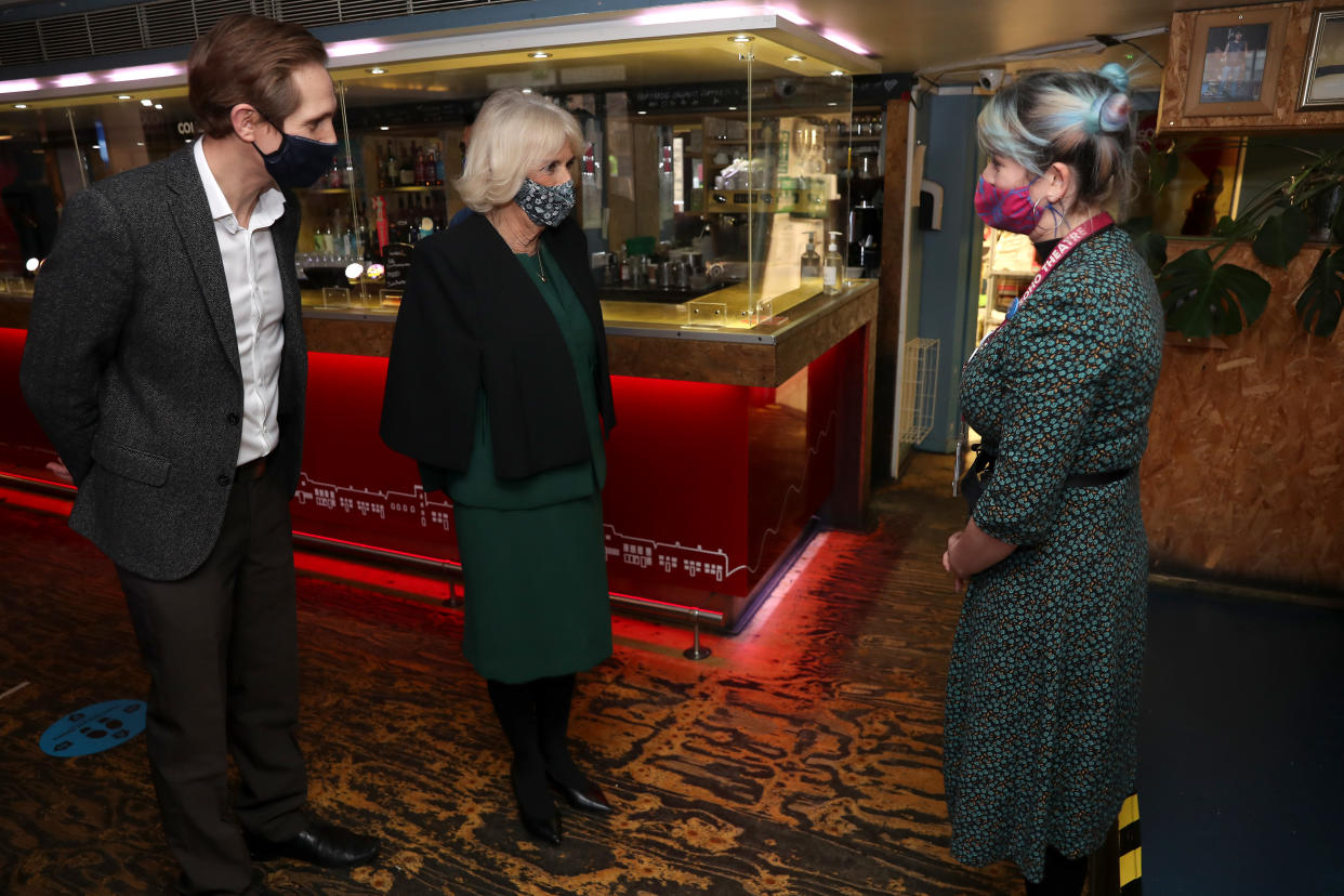 LONDON, ENGLAND - DECEMBER 03: Camilla, Duchess of Cornwall (C) wears a face mask as she speaks to staff during her visit to Soho Theatre with Prince Charles, Prince of Wales to celebrate London's night economy on December 03, 2020 in London, England. (Photo by Chris Jackson - WPA Pool/Getty Images)