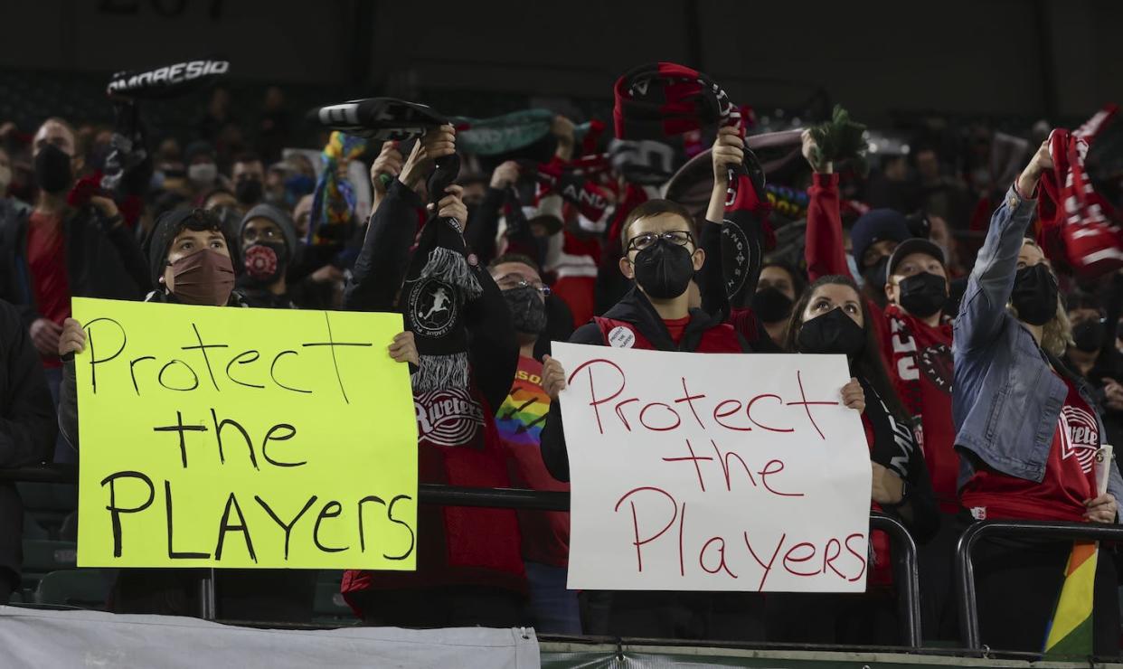 Fans of the Portland Thorns hold protest signs during a game in 2021. <a href="https://newsroom.ap.org/detail/NWSLInvestigationSoccer/58c8718fb762417fbaa3c206e66073ac/photo?Query=women%27s%20soccer%20report&mediaType=photo&sortBy=arrivaldatetime:desc&dateRange=Anytime&totalCount=43&currentItemNo=2" rel="nofollow noopener" target="_blank" data-ylk="slk:AP Photo/Steve Dipaola;elm:context_link;itc:0;sec:content-canvas" class="link ">AP Photo/Steve Dipaola</a>