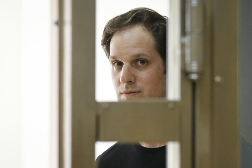 Wall Street Journal reporter Evan Gershkovich stands in a glass cage in a courtroom at the Moscow City Court in Moscow, Russia, Thursday, June 22, 2023. Gershkovich, a Wall Street Journal reporter detained on espionage charges in Russia, appeared in court Thursday to appeal his extended detention.