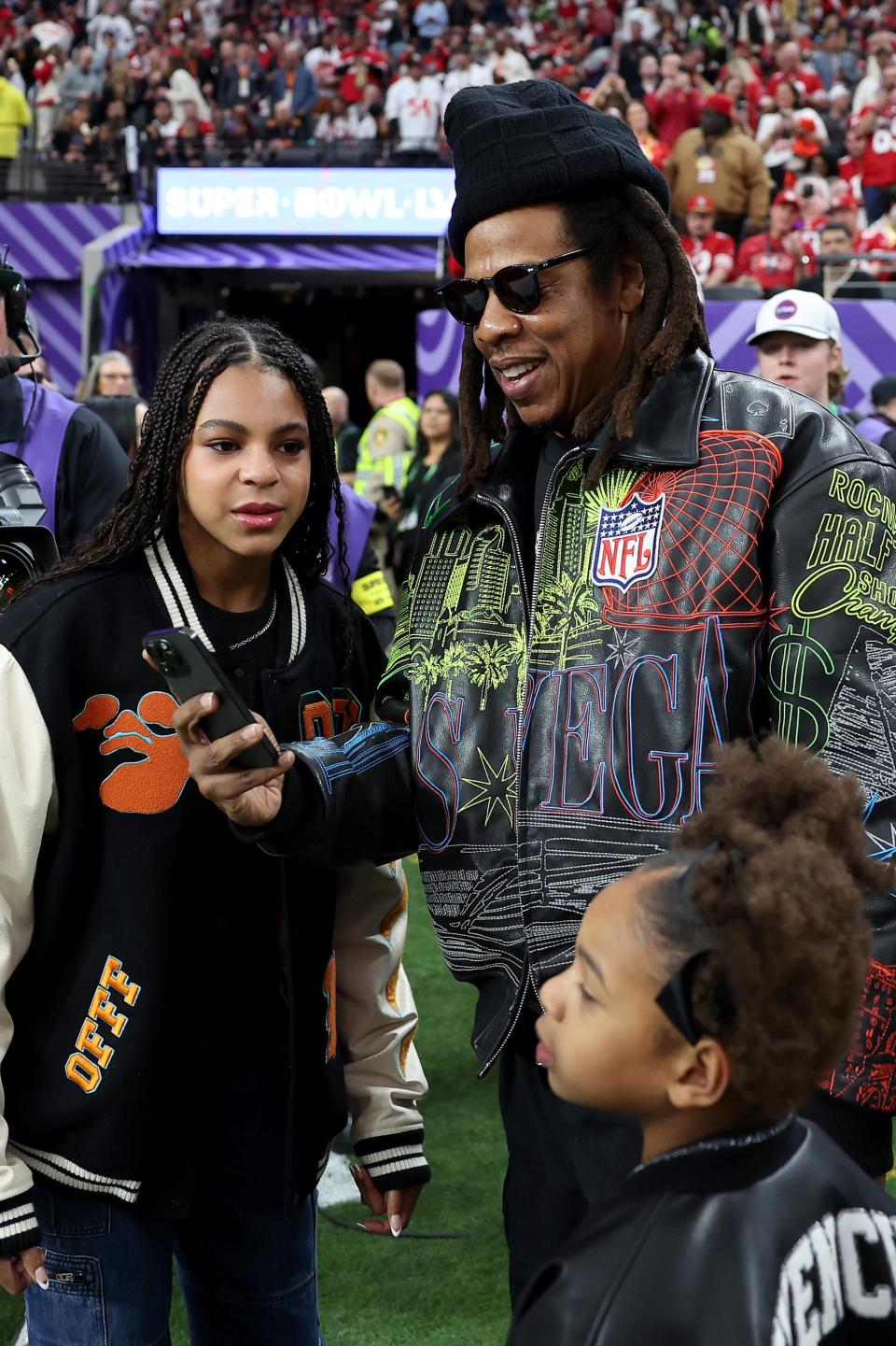 Blue Ivy, Rumi, and Jay-Z on the field