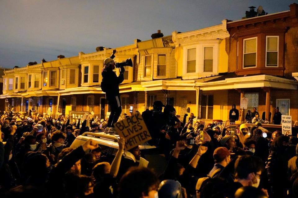 A demonstrator uses a megaphone during a march Tuesday Oct. 27, 2020 in Philadelphia. 