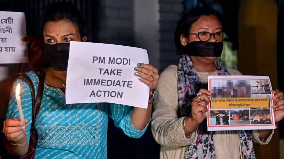 Protesters hold placards during a demonstration over sexual violence against women in Manipur, in Guwahati on Thursday. CNN has blurred a portion of this photograph that showed graphic imagery. - Biju Boro/AFP via Getty Images
