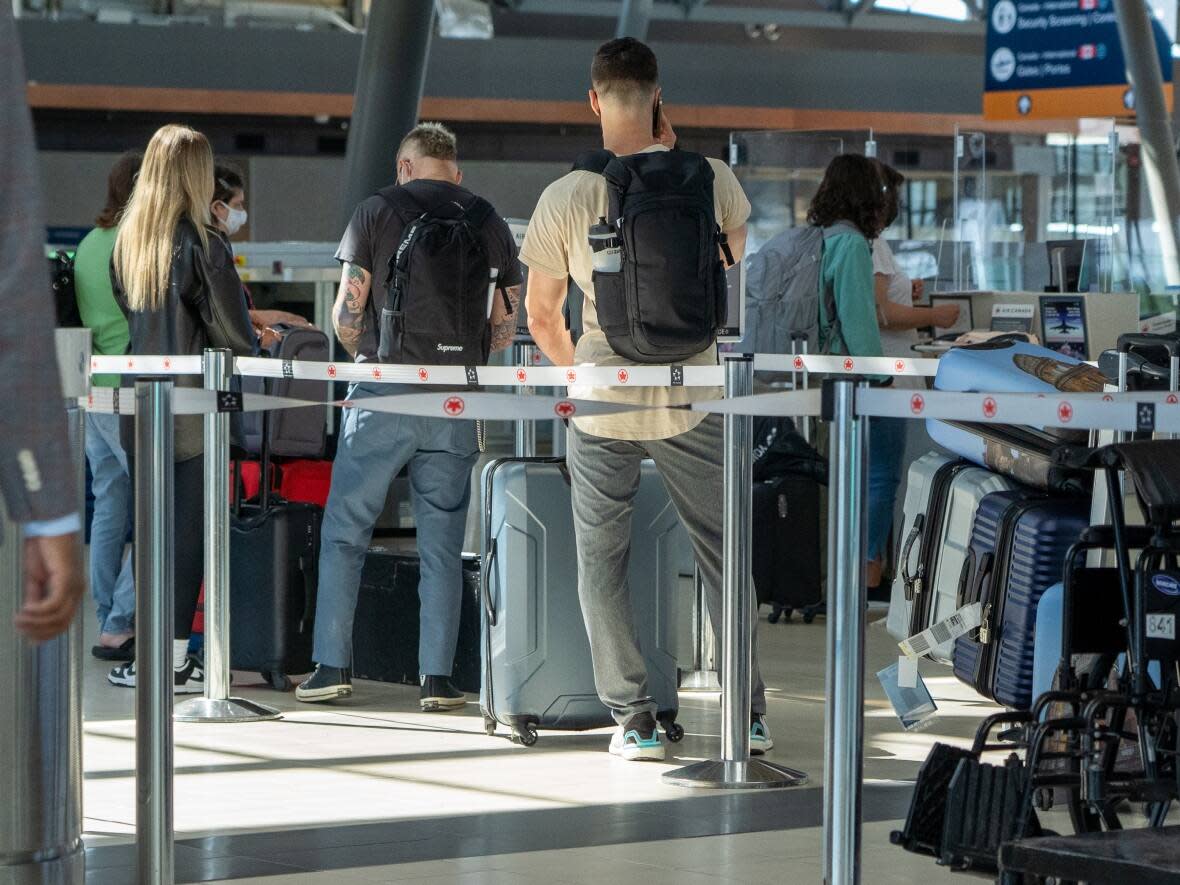 Travellers at the Ottawa International Airport in June 2022. This year, people were allowed to do move more freely, while being asked with various degrees of urgency to follow recommendations instead of rules. (Francis Ferland/CBC - image credit)