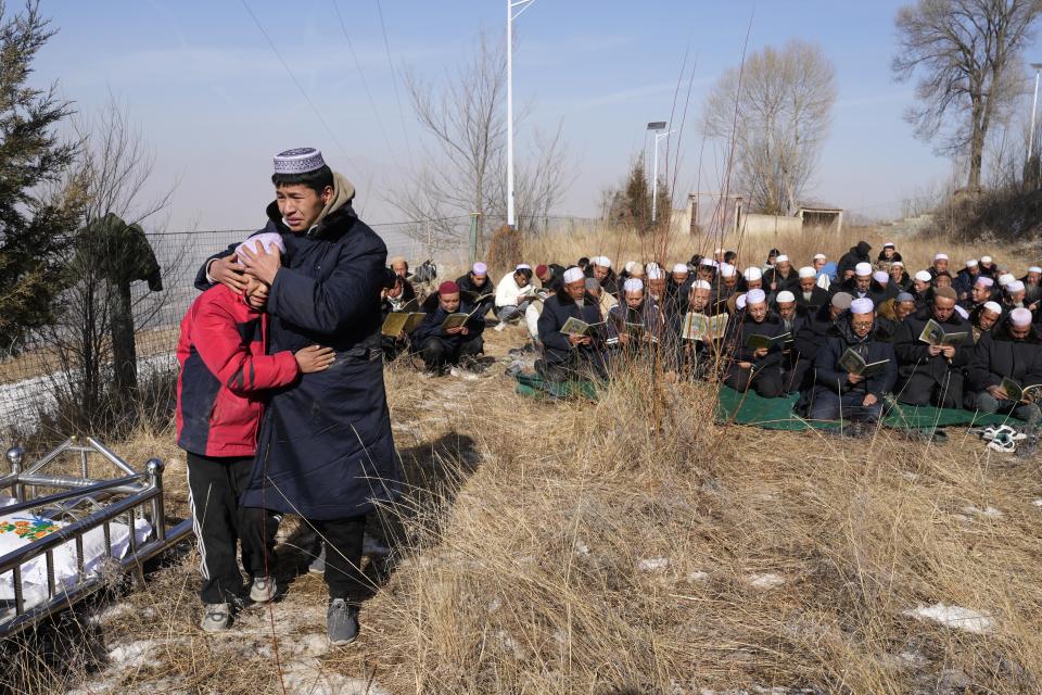 Ma Yuanke, 10, grieves as his mother, Han Suofeiya, who died in an overnight earthquake, is buried in Yangwa village, northwestern China's Gansu province, Wednesday, Dec. 20, 2023. A strong earthquake rattled the mountainous region, reducing homes to rubble, leaving residents outside in a below-freezing winter night and killing more than 130 people in the nation’s deadliest quake in nine years. (AP Photo/Ng Han Guan)