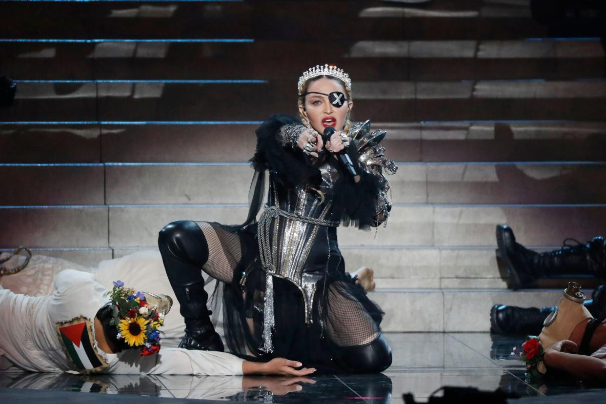 While performing, Madonna sports a magnificent female pirate look with a silver crown and shiny dress