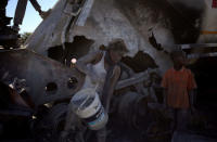 A local loots cement from an AfriSam cement truck during protests in Mahikeng, North West Province, South Africa, April 20, 2018. REUTERS/Siphiwe Sibeko