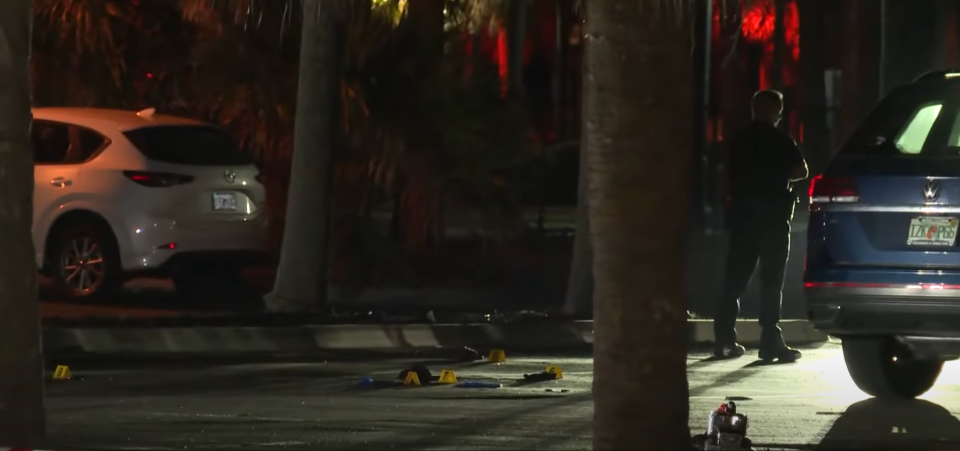 Evidence markers are scattered at the scene of a deadly triple shooting in the Jacksonville Beach bar district as police locked the area down St. Patrick's Day night.