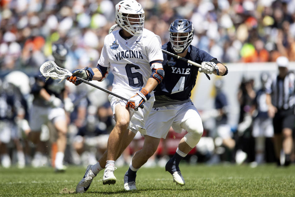 FILE - In this May 27, 2019, file photo, Virginia's Dox Aitken (6) runs with the ball against Yale's Jon Daniggelis (4) during the second quarter of the NCAA college men's Division 1 lacrosse championship in Philadelphia. The NCAA Division I Council is scheduled Monday, March 30, 2020, to vote on providing another year of eligibility to spring sport athletes, such as baseball, softball and lacrosse players, who had their seasons wiped out by the coronavirus pandemic. Providing similar relief to winter sport athletes, such as basketball and hockey players and wrestlers, will also be considered, but according to an memo recently sent to college sports administrators from the NCAA there does not appear to be support for that. (Jose F. Moreno/The Philadelphia Inquirer via AP, File)