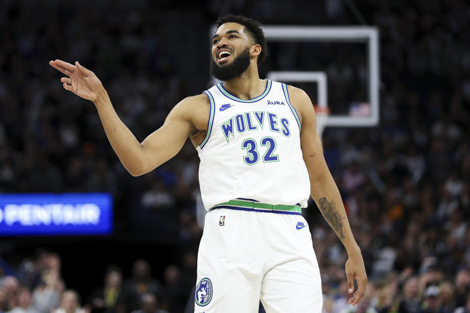 Minnesota Timberwolves center Karl-Anthony Towns (32) celebrates his 3-point basket against the Phoenix Suns during the first half of an NBA basketball game, Sunday, April 14, 2024, in Minneapolis. (AP Photo/Matt Krohn)