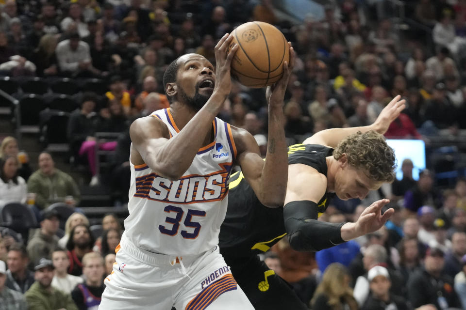 Phoenix Suns forward Kevin Durant (35) goes to the basket as Utah Jazz forward Lauri Markkanen, rear, defends during the first half of an NBA basketball game, Sunday, Nov. 19, 2023, in Salt Lake City. (AP Photo/Rick Bowmer)
