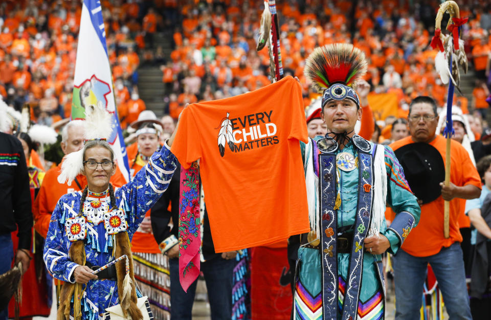 Sherry Starr and Wab Kinew lead the grand entrance at the second annual Orange Shirt Day Survivors Walk and Pow Wow on National Day for Truth and Reconciliation in Winnipeg, Friday, September 30, 2022. THE CANADIAN PRESS/John Woods