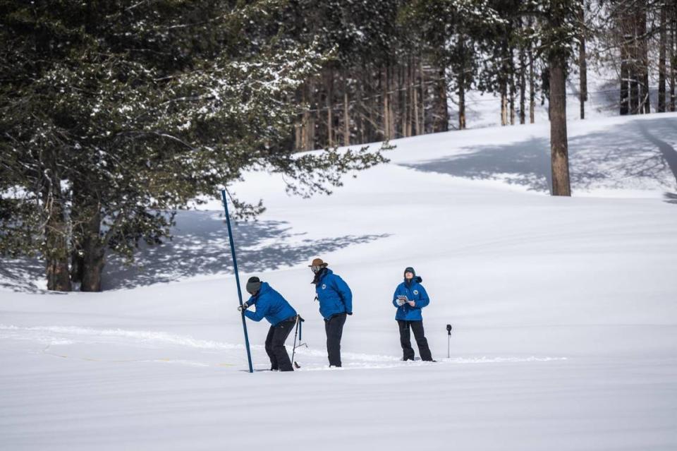 Sean de Guzman, California Department of Water Resources manager, conducts the fourth Phillips Station snow survey of the season with his team Jacob Kollen and Tordan Thoennes, both water resources engineers, on April 3, 2023, at Phillips Station.