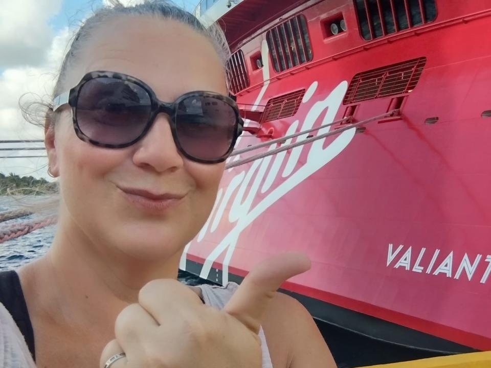woman posing with the Valiant Lady cruise ship