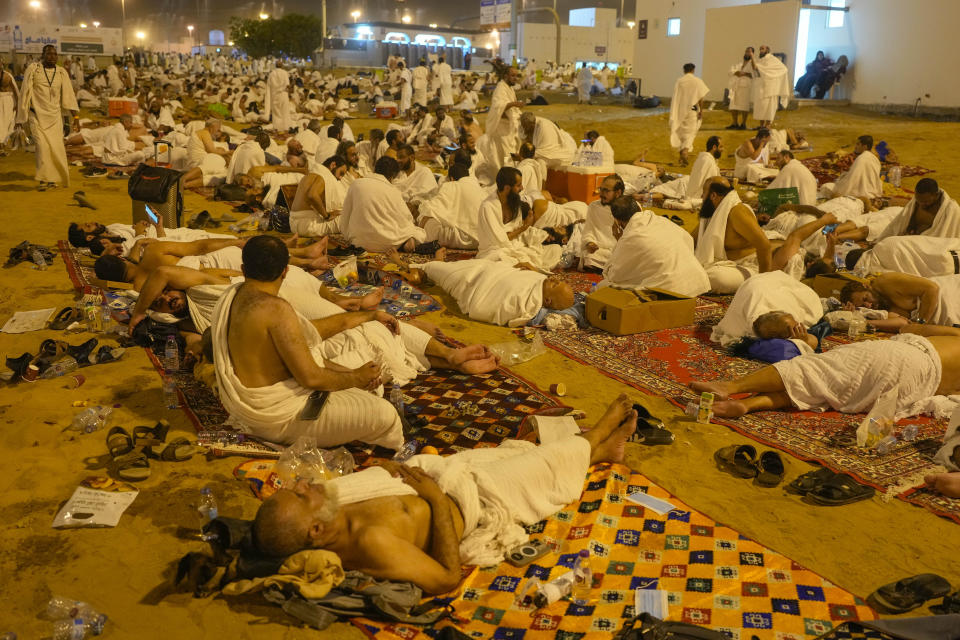 Muslim pilgrims rest in Muzdalifah, on the second day of the annual hajj pilgrimage, near the holy city of Mecca, Saudi Arabia, Saturday, June 15, 2024. (AP Photo/Rafiq Maqbool)