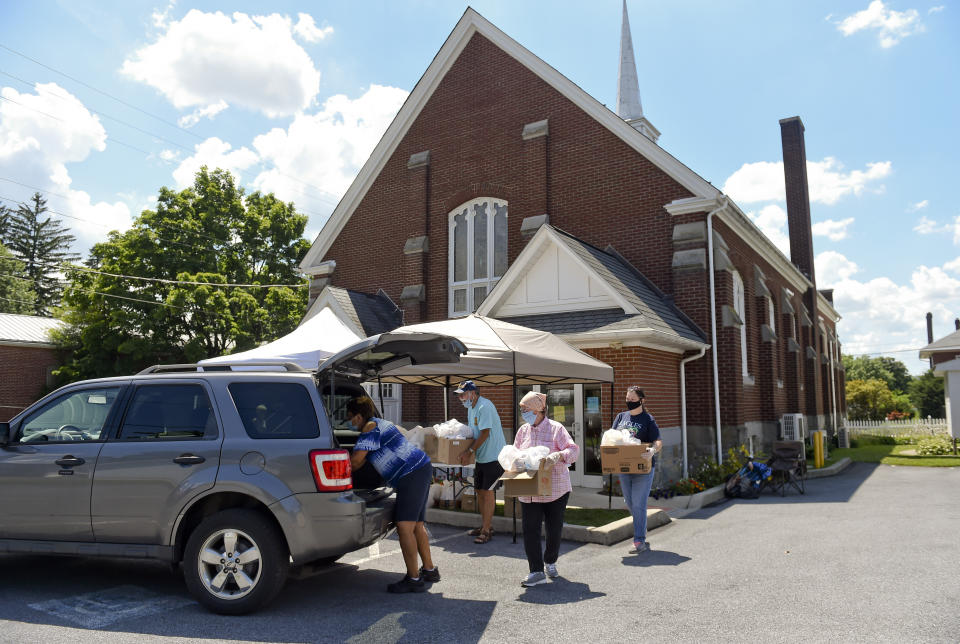 Volunteers load up boxes of food to take to a Franklin and Noble Manor, a nearby senior apartment building. They had a lower than expected turnout, so they checked and found that there were residents there who could use food. During a food distribution at the Salem United Methodist Church in Shoemakersville, PA Wednesday afternoon July 15, 2020. (Photo by Ben Hasty/MediaNews Group/Reading Eagle via Getty Images)