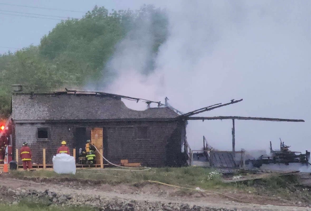 Fire crews work to put out the fire at the Bangor Sawmill Museum early Saturday. (Submitted by Denise Comeau Desautels - image credit)