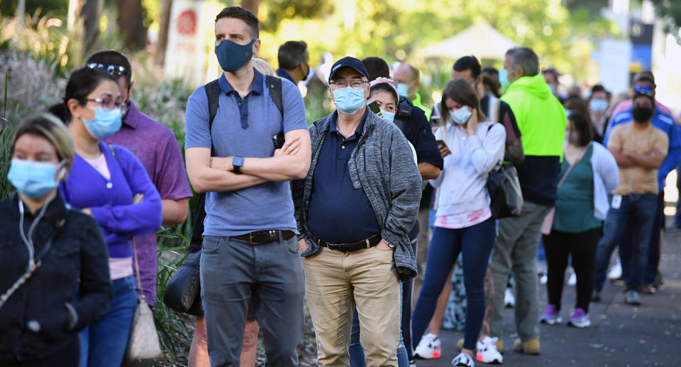 A queue forms outside at a mass COVID-19 vaccination hub in Sydney, Monday, May 10, 2021. The hub will be open to people in categories 1a and 1b before expanding to anyone over 50 from May 24. (AAP Image/Joel Carrett) NO ARCHIVING