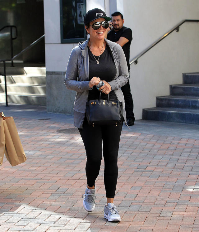 Jennifer Aniston in pink top, blue leggings and brown bucket bag in LA on  July 26 ~ I want her style - What celebrities wore and where to buy it.  Celebrity Style