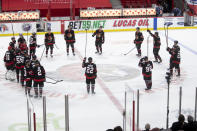 Ottawa Senators players stand at center ice following their final NHL hockey game of the regular season, against the Toronto Maple Leafs on Wednesday May 12, 2021, in Ottawa, Ontario. (Adrian Wyld/The Canadian Press via AP)