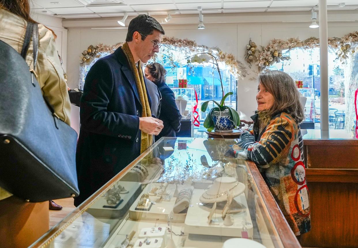 Providence Mayor Brett Smiley chats with Rena Abeles, owner of Reliable Gold Inc., while visiting businesses in Wayland Square on Wednesday.