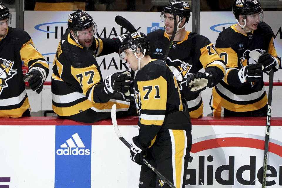 Pittsburgh Penguins' Evgeni Malkin (71) returns to the bench after scoring an empty-net goal against the Vegas Golden Knights during the third period of an NHL hockey game, Sunday, Nov. 19, 2023, in Pittsburgh. (AP Photo/Matt Freed)