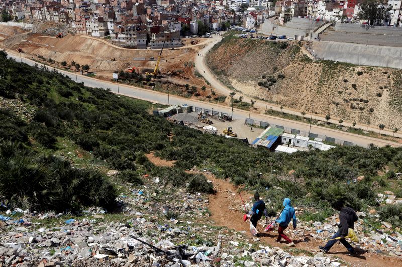 African migrants walk back home at Hay el Farah on the outskirts of Rabat