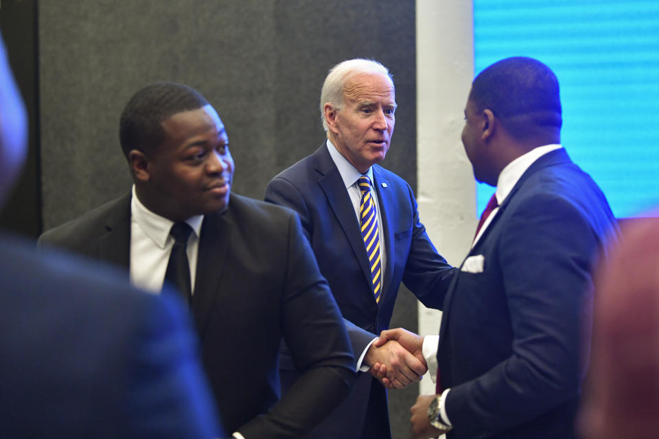 Former Vice President and 2020 Democratic presidential candidate Joe Biden is greeted by Fayetteville (NC) mayor Mitch Colvin, right, after talking to Talladega (Ala.) mayor Timothy Ragland, left, as he visits with an assembly of Southern black mayors Thursday, Nov. 21, 2019 in Atlanta. (AP Photo/John Amis)