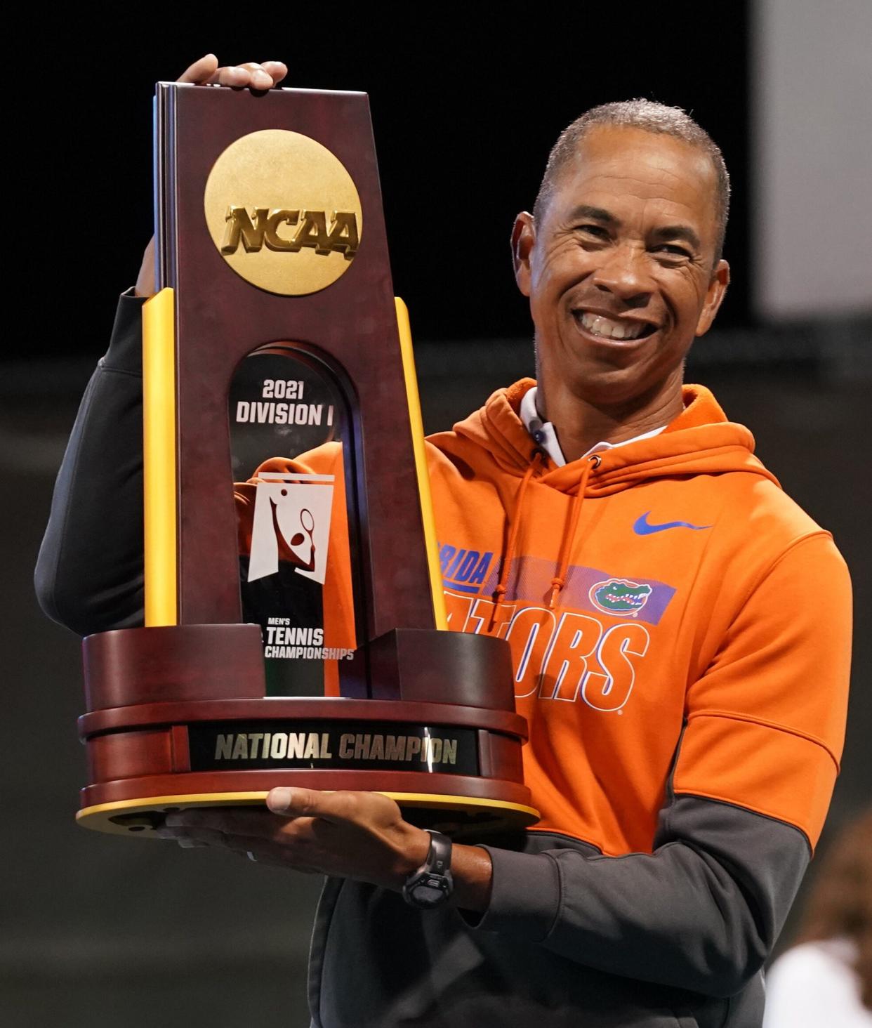 Head coach Bryan Shelton of the University of Florida with the trophy after defeating Baylor University to win the 2021 NCAA D1 Tennis Championships on Saturday, May 22, 2021 at the USTA National Campus in Orlando, Florida. (Manuela Davies/USTA)