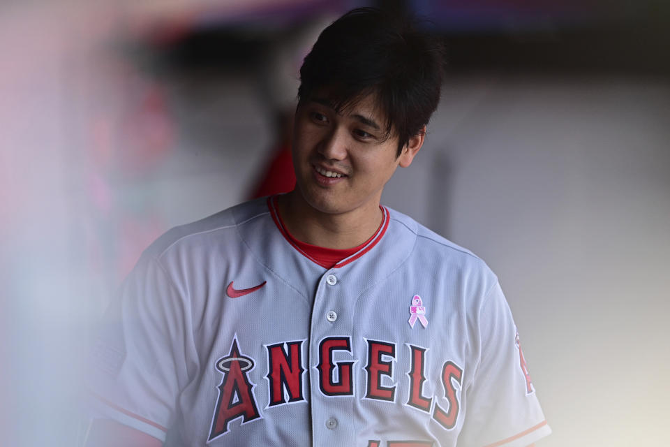 Los Angeles Angels' Shohei Ohtani stands in the dugout during the second inning of a baseball game against the Cleveland Guardians, Sunday, May 14, 2023, in Cleveland. (AP Photo/David Dermer)