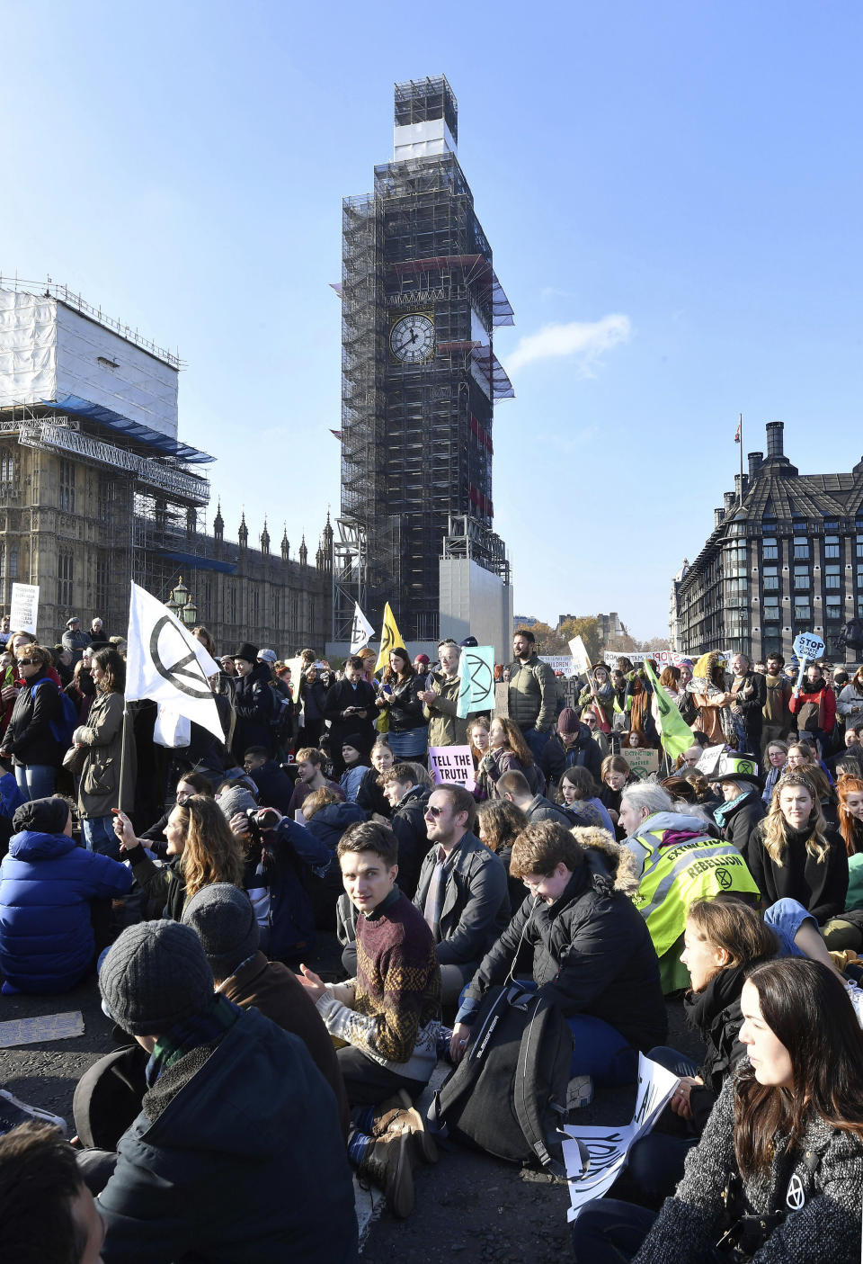 Demonstrators on Westminster Bridge in London, Saturday Nov. 17, 2018, for a protest group called 'Extinction Rebellion' to raise awareness of the dangers posed by climate change. Hundreds of protesters turned out in central London and blocked off the capital’s main bridges to demand the government take climate change seriously. (John Stillwell/PA via AP)