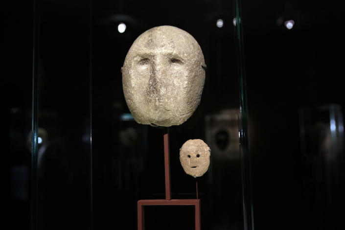 In this Monday, March 10, 2014 photo, 9,000 year-old masks are on display at the Israel Museum in Jerusalem. The exhibition called "Face To Face" shows eleven stone masks, said to have been discovered in the Judean desert and hills near Jerusalem, which date back 9,000 years and offer a rare glimpse at some of civilization’s first communal rituals. (AP Photo/Tsafrir Abayov)