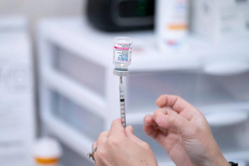 A pharmacist prepares a dose of the Moderna COVID-19 vaccination for children under five at Walgreens pharmacy Monday, June 20, 2022. (AP Photo/Sean Rayford)