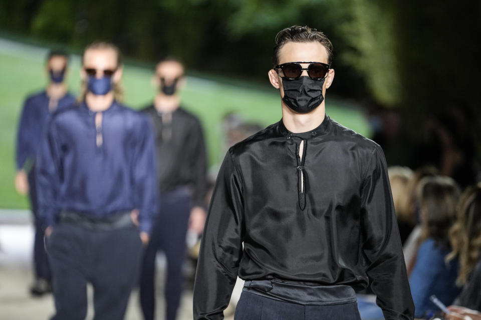 Models wear creations as part of the Giorgio Armani men's Spring Summer 2022 collection, in Milan, Italy, Monday, June 21, 2021. (AP Photo/Luca Bruno)