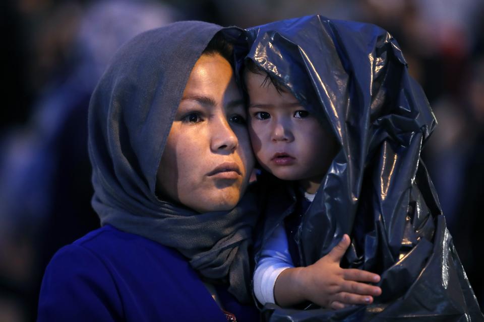 An Afghan woman holds her child upon their arrival from Lesbos island to the port of Piraeus, near Athens, Monday Oct. 7, 2019. In the last 24 hours 668 refugees and migrants have been transferred to mainland Greece from five Greek islands as authorities have accelerated efforts to ease over crowding in the camps. (AP Photo/Thanassis Stavrakis)