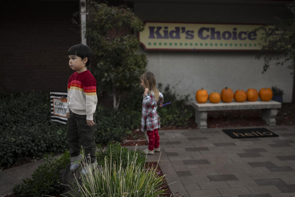 Ethan Quinn, 4, stands on a rock while playing with his classmates outside his daycare center in Concord, Calif., Wednesday, Nov. 1, 2023. Ethan's parents are among those who have opted for a private daycare instead of “transitional kindergarten” — a program offered for free by California elementary schools for some 4-year-olds, expressing the half-day program and options for afterschool child care were limited and didn't work for two parents juggling hectic work schedules. (AP Photo/Jae C. Hong)