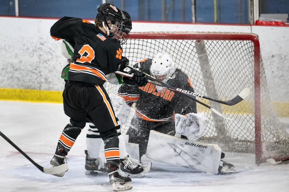 Marlborough's Alex Todd and Wachusett's Thomas Willman slide spraying goalie Roman Belli with ice in the Borough's Cup at North Star Ice Sports on Saturday December 16, 2023.