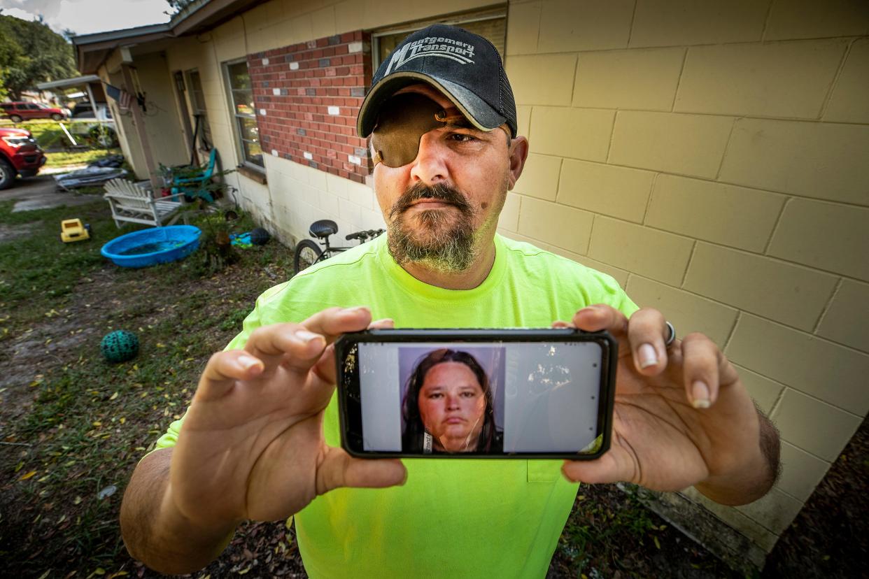 Matthew Gardner holds up a photo of his cousin, Anna Catherine Haney, who has been arrested multiple times for threatening to kill her various family members. She is awaiting trial for threatening to kill Gardner, his wife and their children.