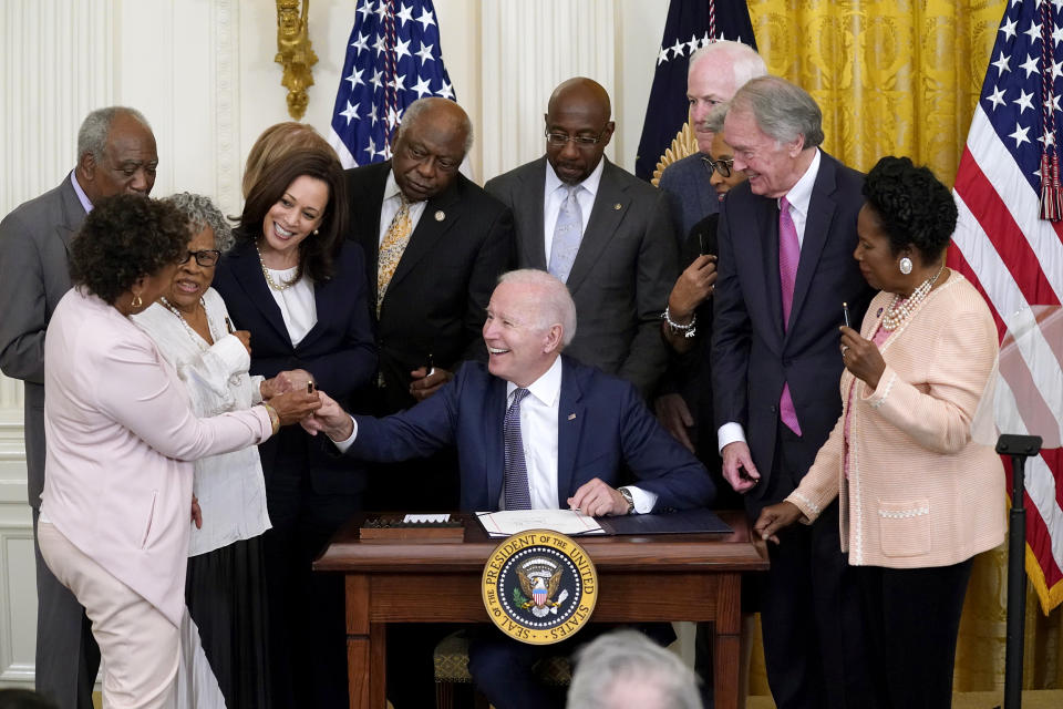 Image: President Joe Biden hands a pen to Rep. Barbara Lee, D-Calif., after signing the Juneteenth National Independence Day Act, in the East Room of the White House on June 17, 2021. (Evan Vucci / AP)